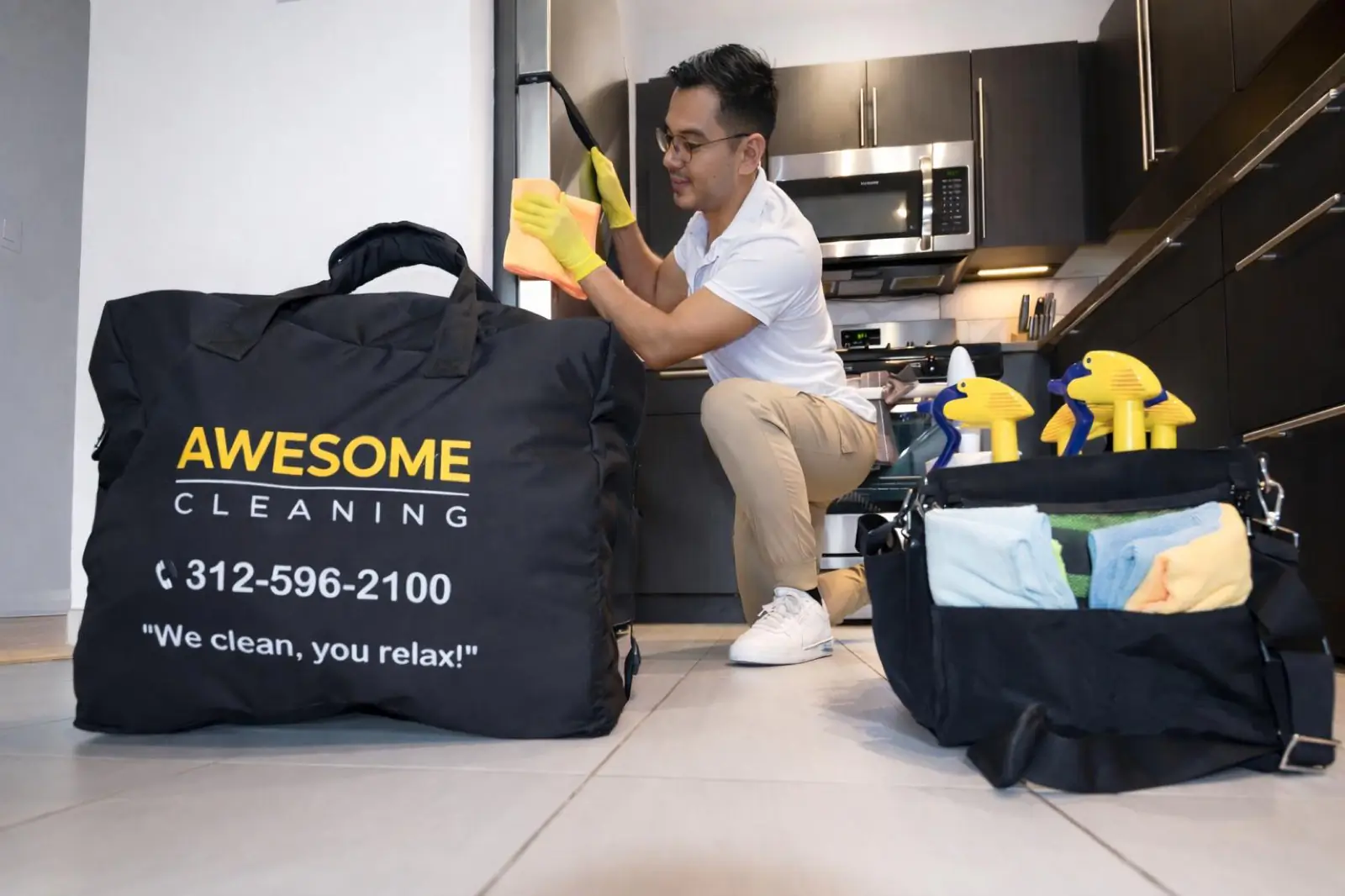 Awesome Cleaning team member detailing a Chicago kitchen with the branded supply bag